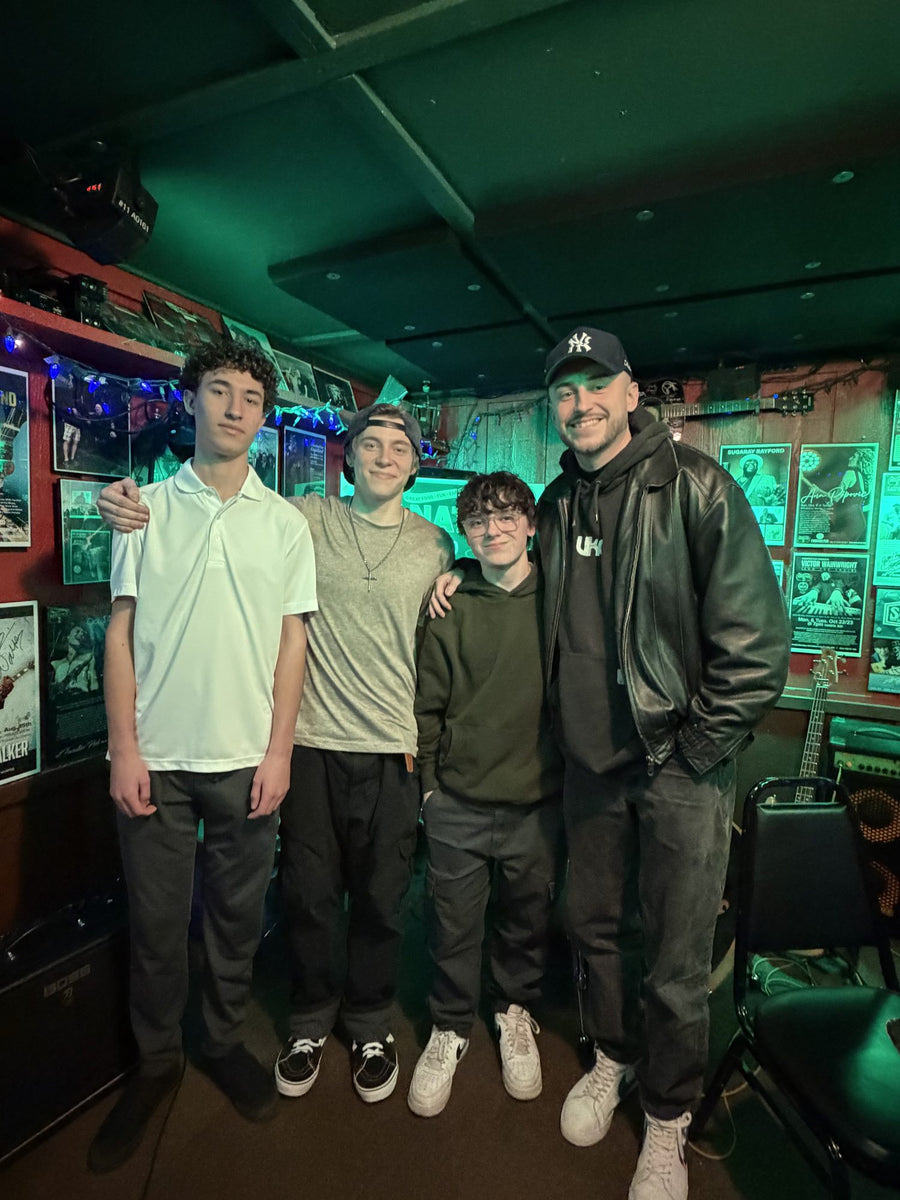Ryan Barski with three of his student musicians at a live music venue