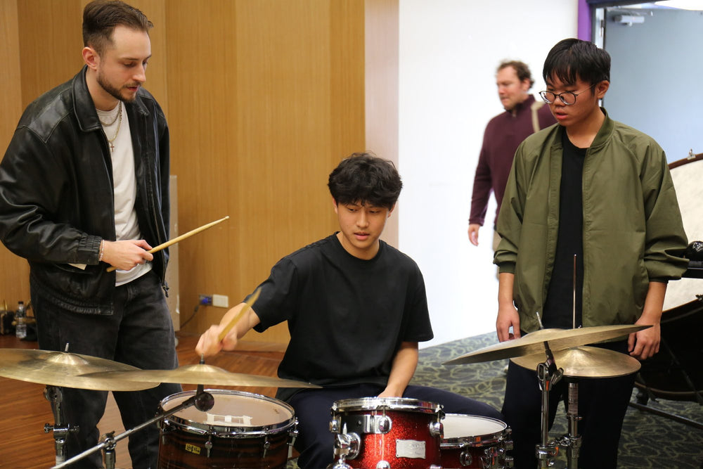 Ryan Barski coaching a drum student during a masterclass in Taiwan