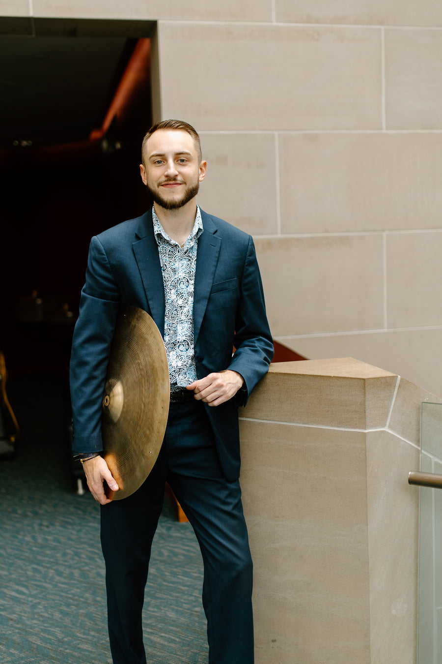 Ryan Barski smiling and holding a cymbal