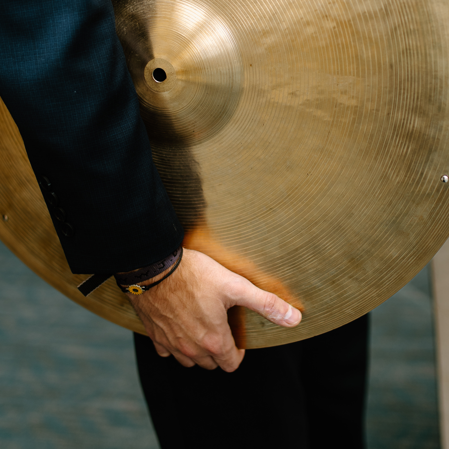 Ryan Barski holding a ride cymbal at his side